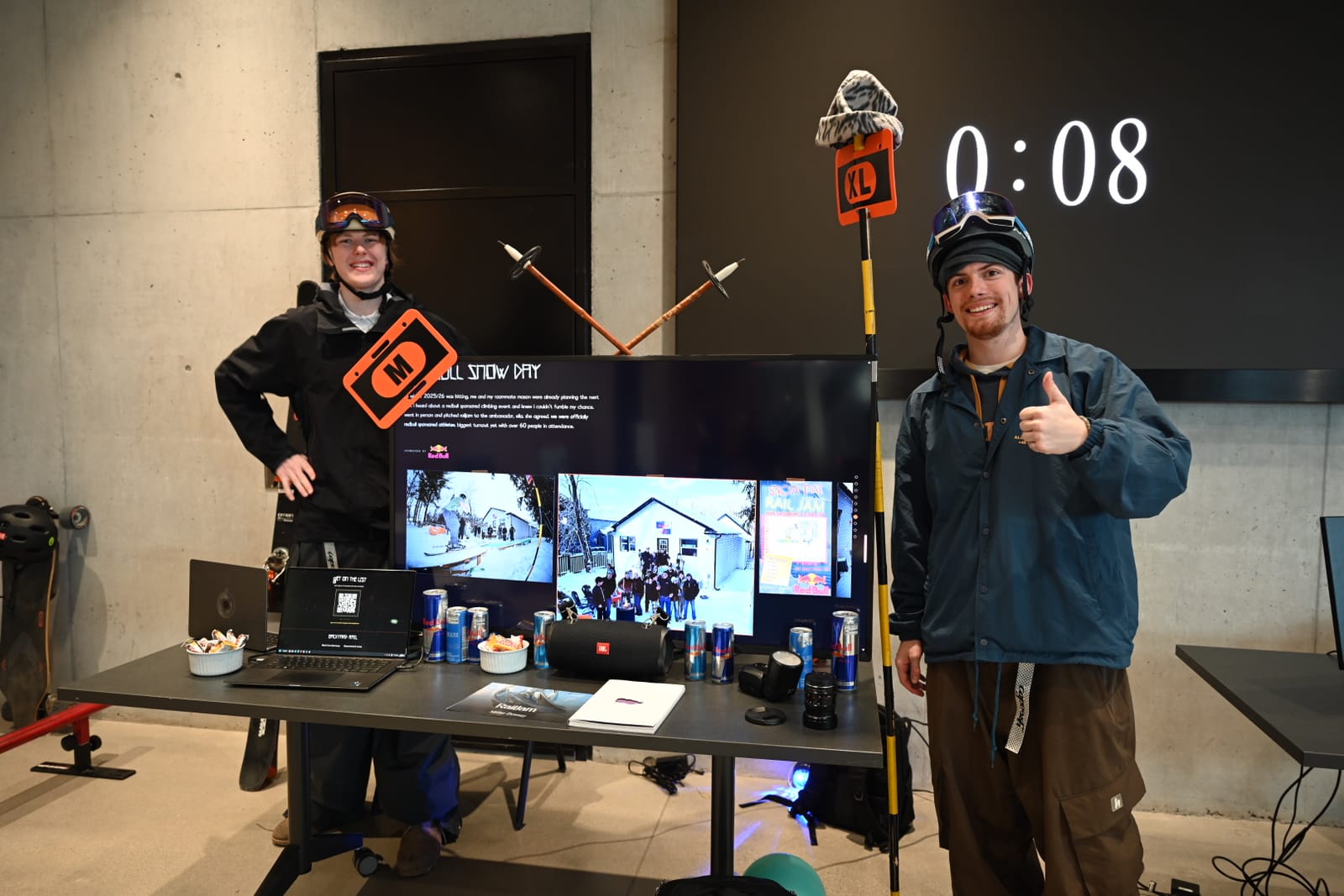 Miller and Mason presenting the Red Bull Snow Day railjam at a demo table