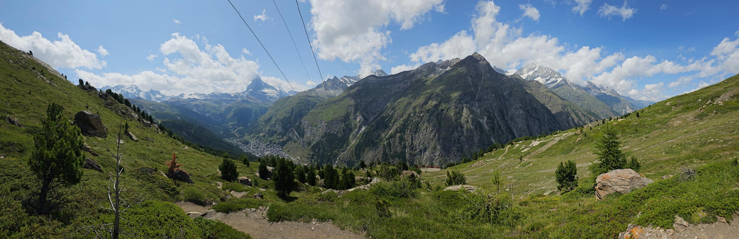 Panorama over the Zermatt valley from a hiking trail, the Matterhorn on the horizon